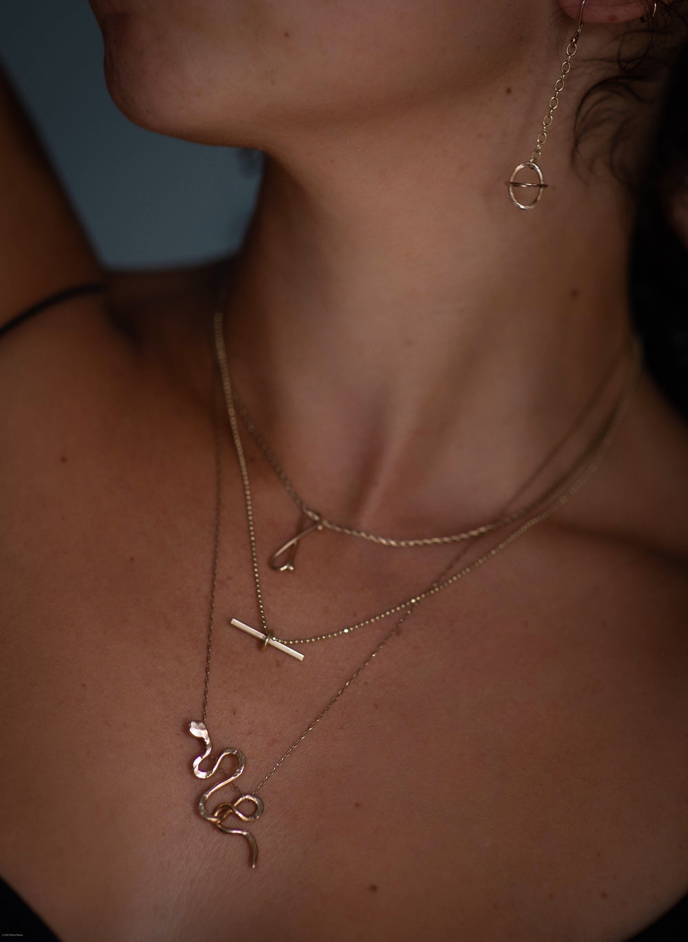 Orbit Ovals oval gold earrings handcrafted by Anaïs & Alaïa on model ear